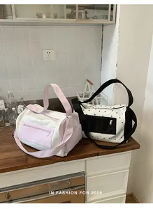 Detailed view of pink and black star patterned gym bags placed on a wooden countertop