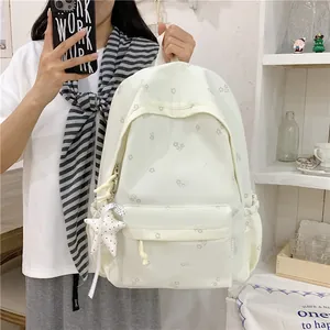 Stylish white floral print backpack with cute star charm detail for casual travel