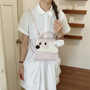 Detail view of the pink cartoon dog backpack worn by a model in a white dress