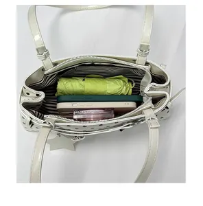 Top-down view showing spacious interior of polka dot shoulder bag with striped lining