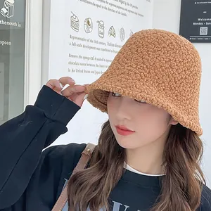 Cozy brown lambswool bucket hat for women, fashionable winter fleece fisherman hat accessory.