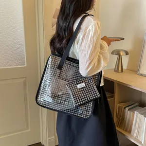 Detail view of large capacity grid pattern tote bag with matching pouch worn by model