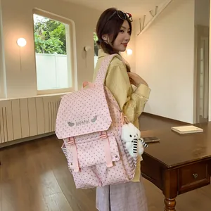 Stylish pink women's backpack featuring gray star patterns and a cute bunny charm