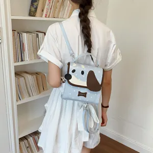 Cute light blue dog-themed mini backpack for women shown in a lifestyle library setting
