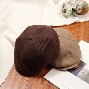 Close-up detail of vintage knitted newsboy caps in brown and tan for women's autumn wear