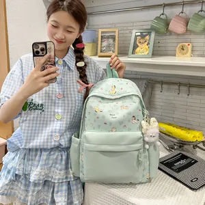 Close-up view of a mint green Japanese style cartoon backpack with cute animal prints