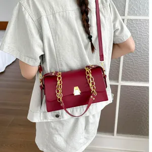 Wine red fashion crossbody bag with gold chain strap for women, elegant daily accessory.