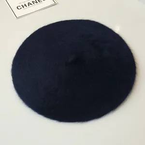 Macro view of a soft navy blue rabbit fur beret for women, warm winter fashion accessory detail