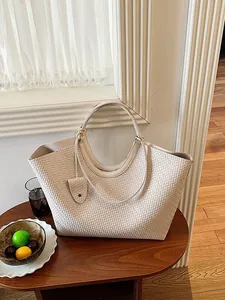 Elegant beige woven tote bag with large capacity in a minimalist interior setting
