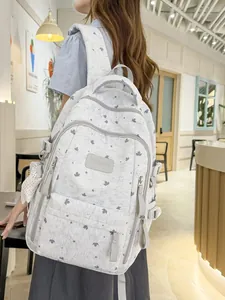 Stylish white backpack with maple leaf and star pattern for casual outdoor travel.
