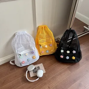 Fashionable large capacity mesh drawstring backpacks with colorful knitted flower accents