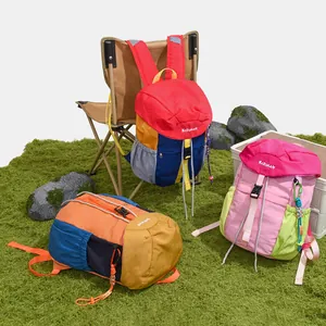 Collection of multi-colored casual backpacks in a professional outdoor camping scene.