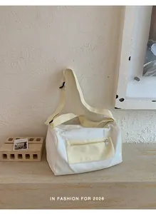 Minimalist white and yellow fitness bag displayed against a textured wall background