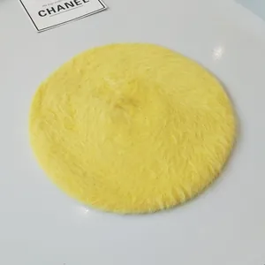 Detailed view of a soft yellow rabbit fur beret hat for women with fluffy texture for winter
