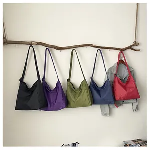Detailed view of large capacity checkered nylon bags in various vibrant colors hanging