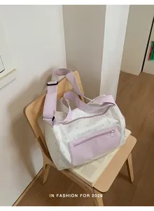 Lavender star pattern sports duffel bag with front pocket in a clean indoor setting
