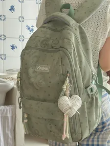 Mint green high-capacity school backpack with heart pattern and plush pendant