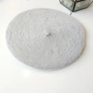 Close-up of a soft light grey fuzzy angora beret hat showing plush knit texture and detail