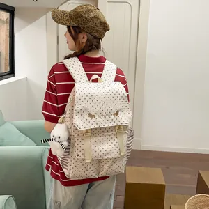 Back view of a stylish star-patterned backpack worn by a model in a casual setting