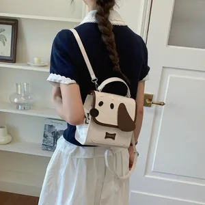 Detailed view of a cute cream dog-face backpack worn by a model in a cozy setting