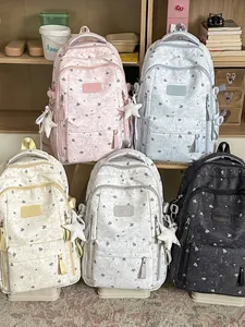 Group of casual school backpacks with star patterns in various pastel and dark colors.