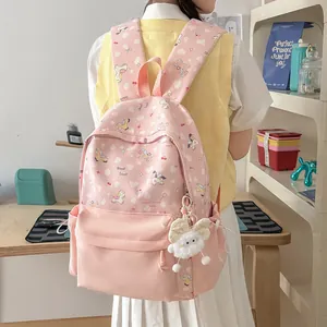 Back view of a pink cartoon backpack with cute pony patterns and plush bunny charm