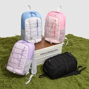 Variety of colorful outdoor sports backpacks showcased on a natural grass scene