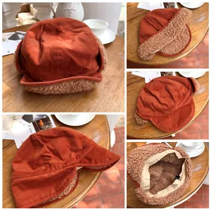Detailed views of an orange corduroy winter hat with cozy plush ear flaps and lining.