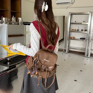 Stylish brown leather backpack featured in a cozy lifestyle coffee shop setting