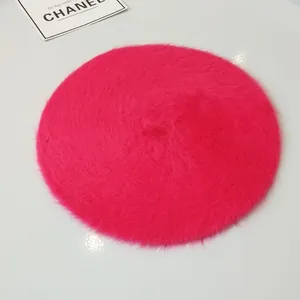 Close-up of the fluffy texture on a vibrant pink rabbit fur beret for winter fashion