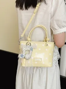 Summer yellow polka dot handbag for women with a cute music note charm detail