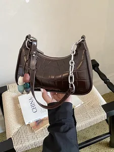 Trendy dark brown crocodile texture dumpling crossbody bag featuring a silver chain