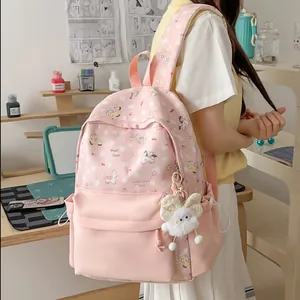 Detailed view of pink kawaii cartoon backpack with pony pattern and plush charm