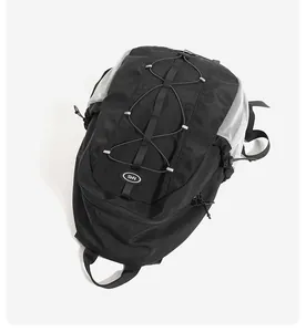Close-up of black multi-functional backpack with bungee cord detail and NMS logo