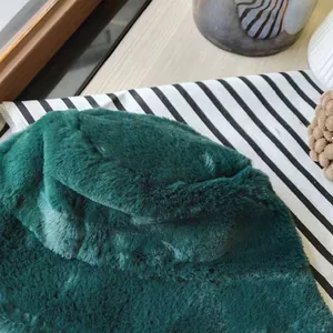 Detail shot of the soft emerald green faux fur texture on a winter bucket hat