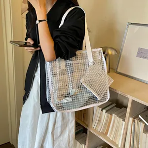 Detailed shot of large transparent mesh tote bag featuring a matching small pouch accessory