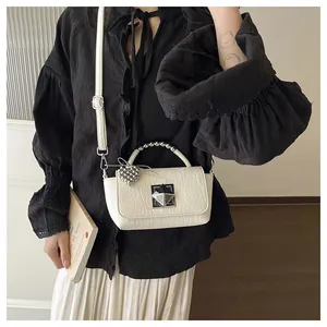 Elegant cream textured small square handbag with silver heart charm and metal handle