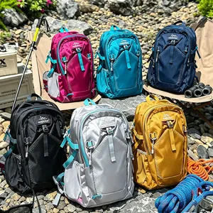 Collection of multi-color outdoor hiking backpacks displayed in a rugged mountain setting