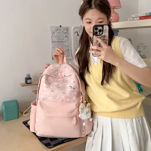 Close-up of a pink Japanese style cartoon backpack with cute pony patterns and plush charm