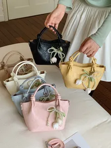 Trendy summer bucket handbags for women with bow charms and pearl tulip pendants