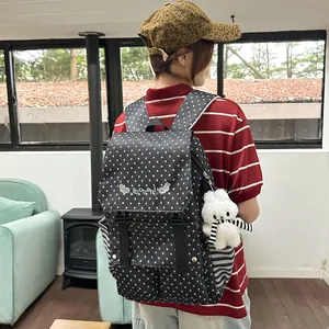 Stylish black backpack with white star pattern and cute bunny plush charm detail