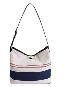 Versatile minimalist striped canvas hobo tote bag with adjustable black shoulder strap