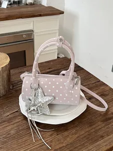 Stylish pink polka dot cylindrical handbag with cute star and horse charms for women