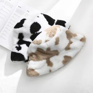 Close-up showing the soft plush texture of cow print winter bucket hats for women