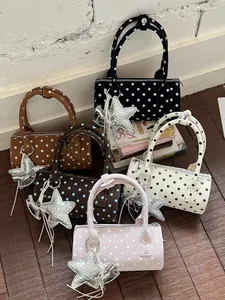 Stylish polka dot cylinder handbags with silver star charms in multiple vibrant colors