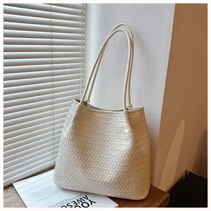 Detailed view of cream woven tote bag showcasing retro texture and large capacity