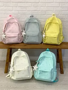 Set of five fashionable student backpacks in pastel colors featuring star patterns