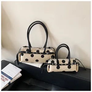 Detailansicht minimalistischer Polka-Dot-Zylindertaschen in zwei Größen für vielseitigen Stil