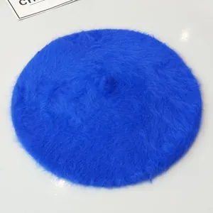 Top down view of a vibrant blue fuzzy rabbit fur beret hat providing winter warmth