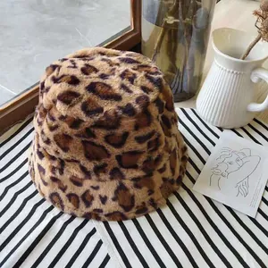 Close-up of a stylish leopard print plush bucket hat with soft faux fur texture detail.